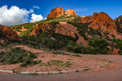 Scenic view of land and mountains against sky