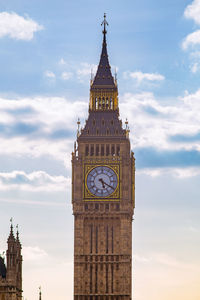 Low angle view of clock tower against sky