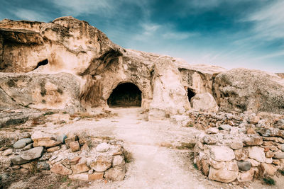 Old ruins of building against cloudy sky