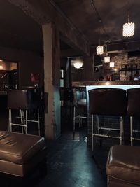 Empty chairs and tables in illuminated restaurant