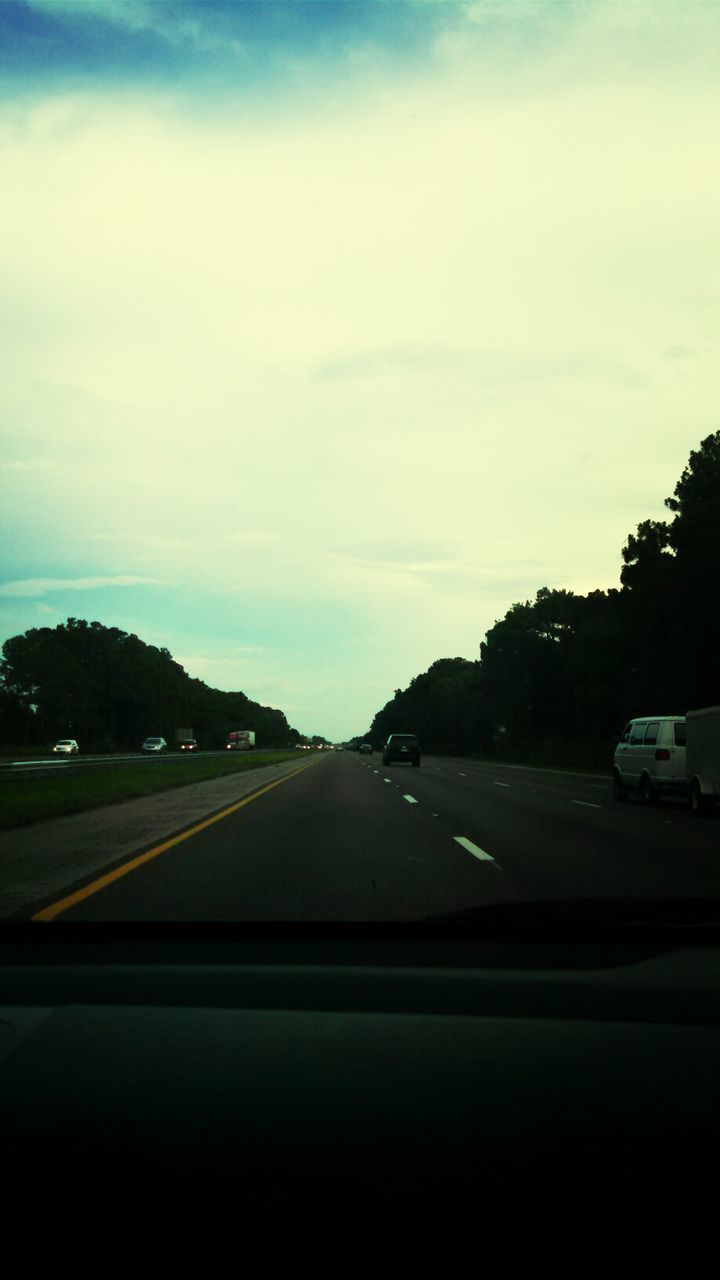 transportation, car, road, land vehicle, mode of transport, sky, road marking, windshield, the way forward, street, cloud - sky, tree, car interior, vehicle interior, travel, on the move, cloud, diminishing perspective, highway, car point of view