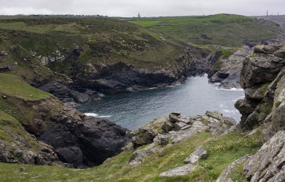 Scenic view of sea and mountains against sky