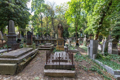 Statues against trees and plants