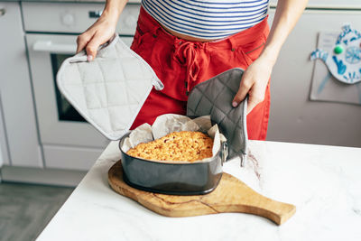 Low section of woman standing by food