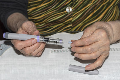 Close-up of man hand on table
