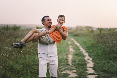 Happy fathers day. father with son are walking in the field.