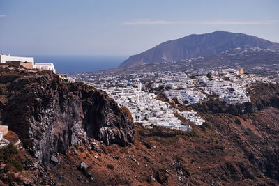 Panoramic aerial view of fira village in santorini island, greece - traditional white houses