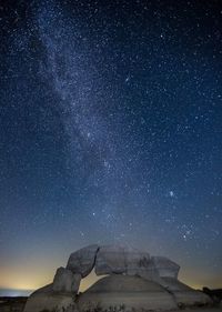 Scenic view of rocks against star field at night