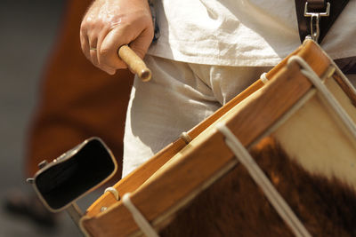 Midsection of man playing guitar