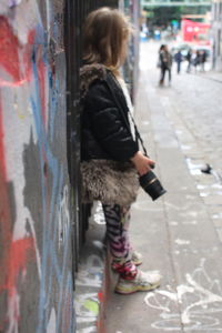 Full length of woman on snow covered city