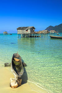 View of boat on shore of tropical beach