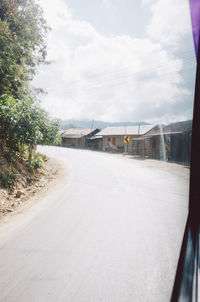 Empty road against sky during winter