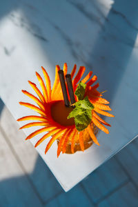 High angle view of orange flower on table