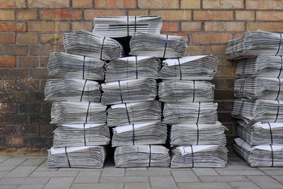 Stack of newspapers on sidewalk