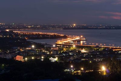 High angle view of illuminated cityscape against sky at night