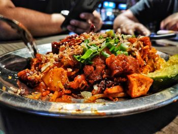 Close-up of person preparing food in plate