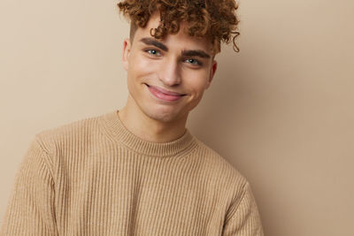 Portrait of young man against wall