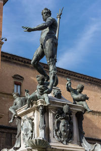 Low angle view of statue against building