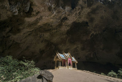 People on rock formation in cave