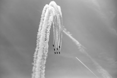 Low angle view of airplane flying against sky