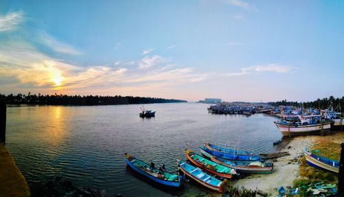 Boats moored in city against sky