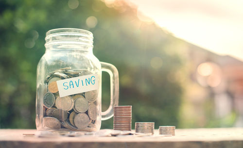 Close-up of coins in jar on table