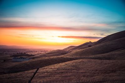 Scenic view of landscape against sky during sunset