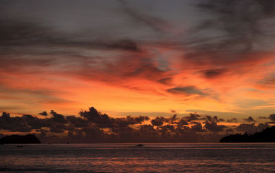 Scenic view of sea against romantic sky at sunset