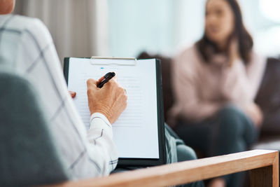 Side view of woman using laptop at office