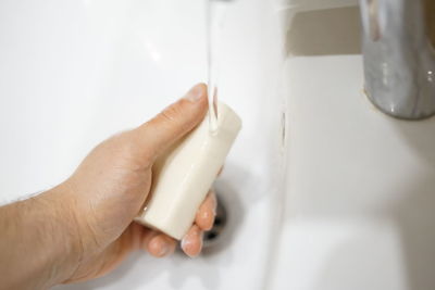 High angle view of person hand on white wall at home