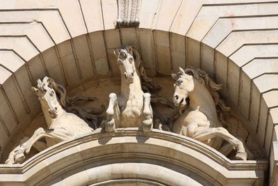 Low angle view of statues on historic building