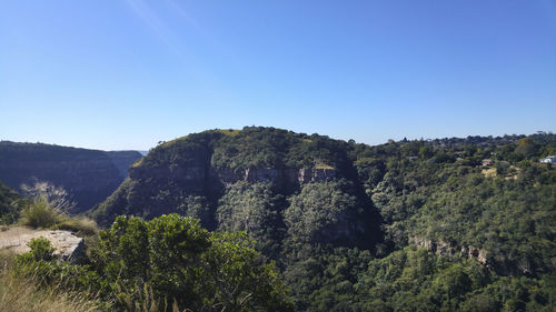 Scenic view of mountains against clear blue sky