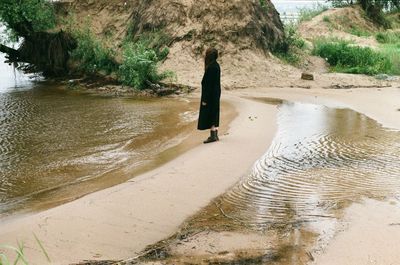 Rear view of woman walking on beach