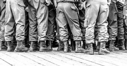 Low section of people standing on tiled floor