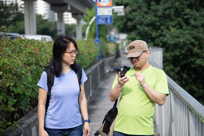 Young man and woman standing outdoors