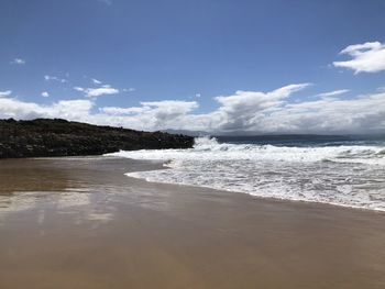 Scenic view of beach against sky