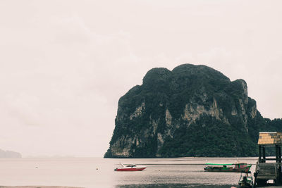 Scenic view of sea and rocks against sky