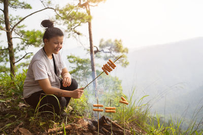 Camping cook concept, asian women cooking on the mountain.