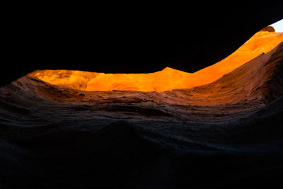 Scenic view of volcanic mountain against sky during sunset