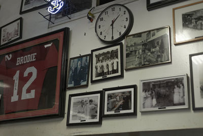 Close-up of clock hanging on wall at store