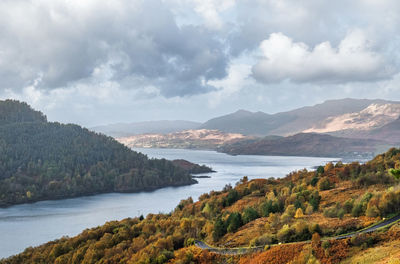 Scenic view of sea and mountains against sky