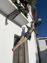 Low angle view of telephone pole against buildings