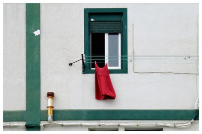 Red dress hanging on the clothesline.