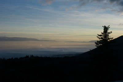 Scenic view of silhouette mountains against sky at sunset