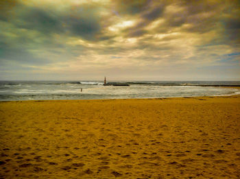 Scenic view of sea against cloudy sky