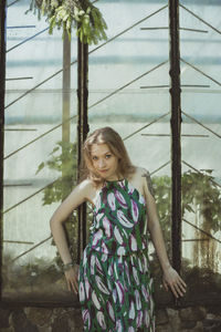 Young woman in dress posing with awkward smile scenic photography