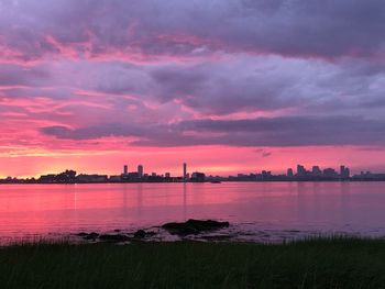 Scenic view of lake against orange sky