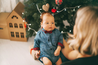 Mother holding baby boy at home