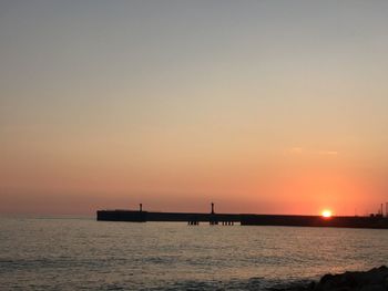 Scenic view of sea against orange sky