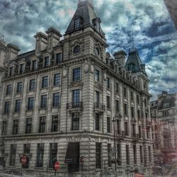 Low angle view of building against cloudy sky